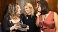 Three alumnae chatting happily
